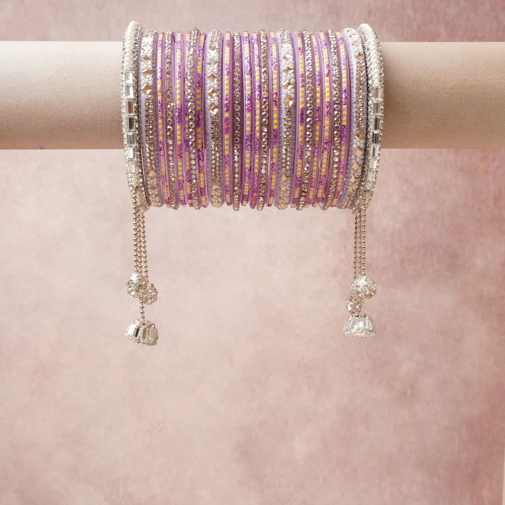 A grounding Lavender forms the heart of the set, while touches of Bright Yellow, Amethyst, Silver, Clear, Cream, Warm Gold add charm.

A thoughtful composition of Glass, Lacquer, Rhinestones, Imitation Pearls, Silver-toned Metal, Glitter, designed to feel complete without being heavy.
Each element layers seamlessly, creating a look that is refined, wearable and quietly striking.